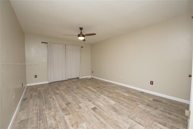 empty room with a ceiling fan, baseboards, and light wood finished floors