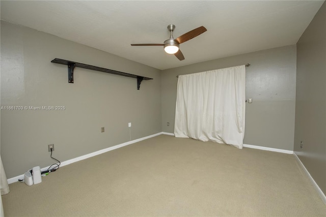 spare room featuring carpet, baseboards, and a ceiling fan