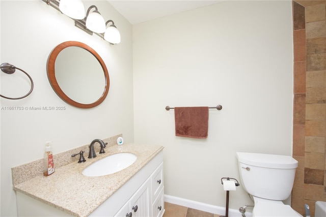 full bathroom with toilet, baseboards, and vanity