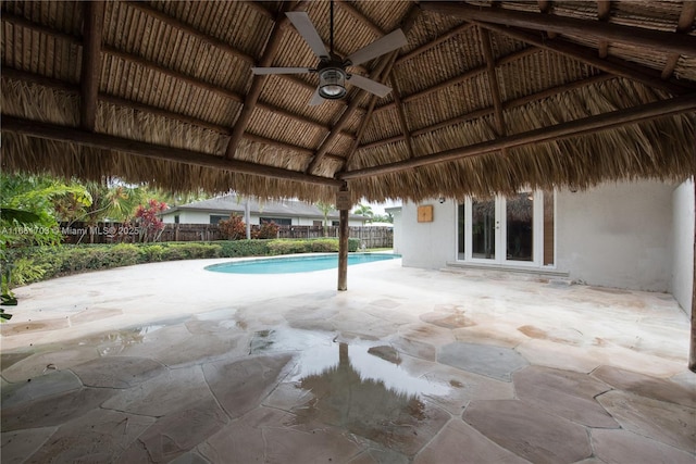 outdoor pool with ceiling fan, a patio, french doors, and fence