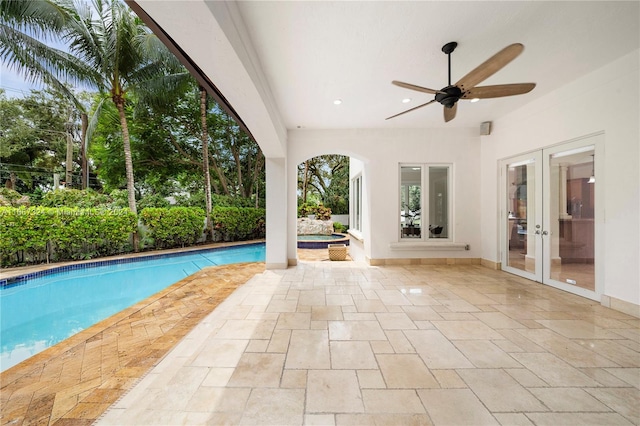 view of pool with a patio, ceiling fan, and french doors