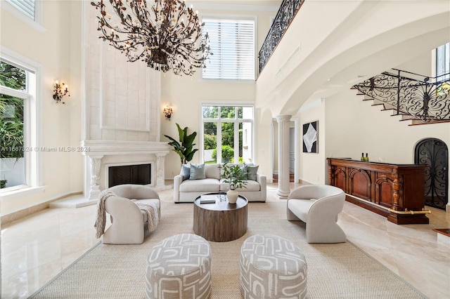 living room featuring decorative columns and a towering ceiling