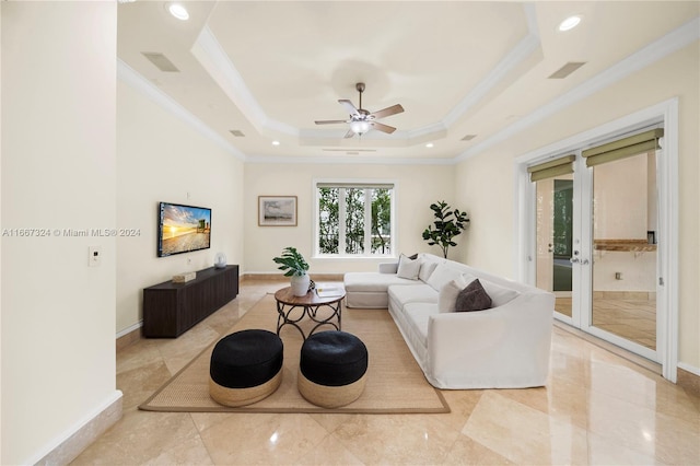 living room with crown molding, a tray ceiling, ceiling fan, and french doors