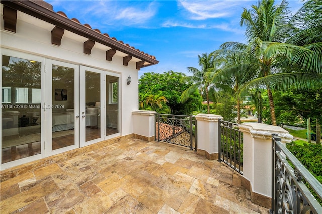 view of patio / terrace featuring a balcony and french doors