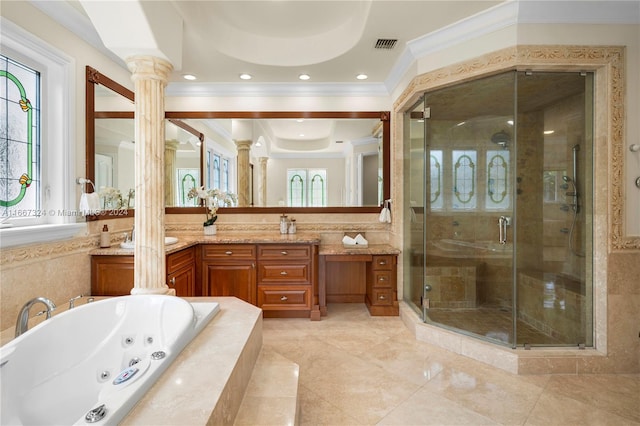 bathroom with independent shower and bath, vanity, plenty of natural light, and decorative columns