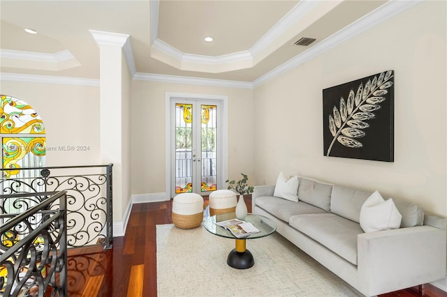 living room featuring french doors, a raised ceiling, dark hardwood / wood-style floors, and crown molding