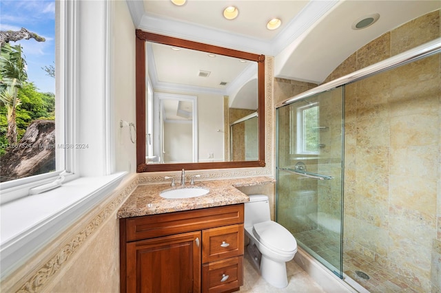 bathroom featuring ornamental molding, vanity, a shower with shower door, and toilet