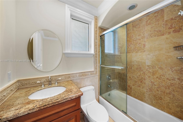 full bathroom with bath / shower combo with glass door, vanity, tile walls, and toilet