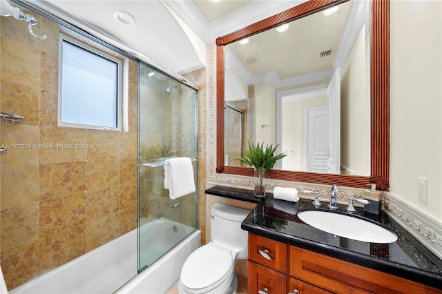 full bathroom with crown molding, vanity, toilet, and bath / shower combo with glass door