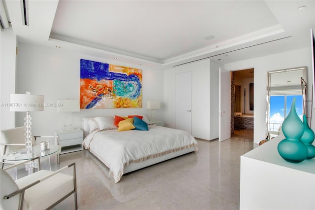 bedroom featuring a raised ceiling