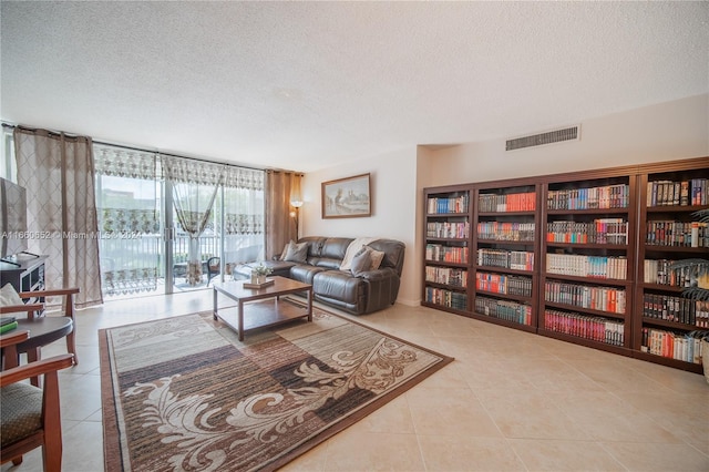 tiled living room with a textured ceiling