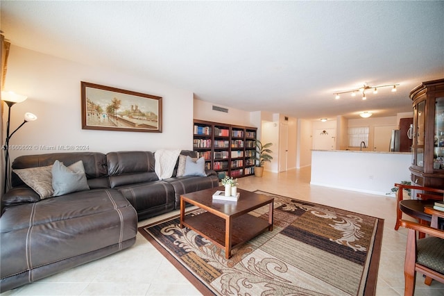 living room with tile patterned flooring and a textured ceiling