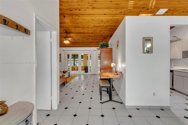 interior space with white cabinets, ceiling fan, wooden ceiling, and french doors