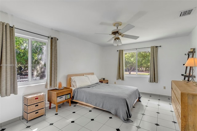 bedroom with multiple windows and ceiling fan