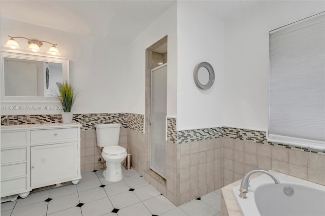 full bathroom featuring vanity, plus walk in shower, tile patterned floors, tile walls, and toilet