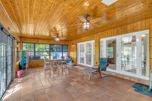 unfurnished sunroom featuring ceiling fan, french doors, and wooden ceiling