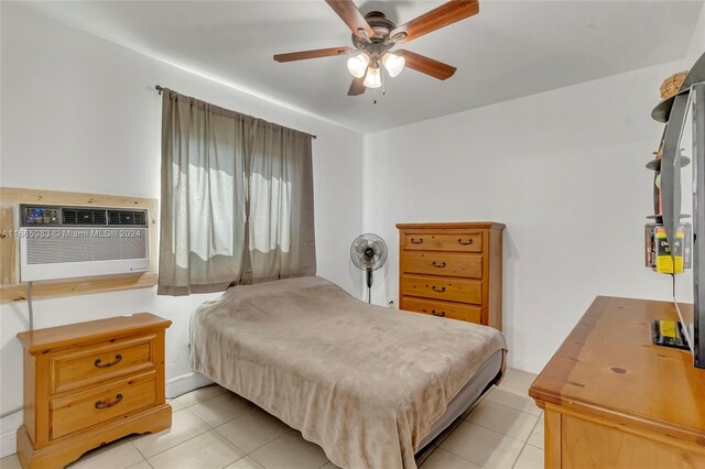 tiled bedroom featuring ceiling fan