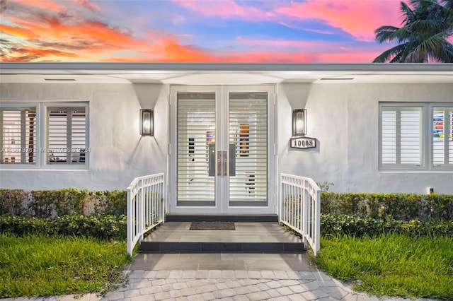 exterior entry at dusk featuring french doors