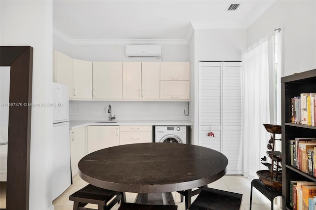 kitchen featuring a wall mounted air conditioner, sink, washer / clothes dryer, ornamental molding, and light tile patterned floors