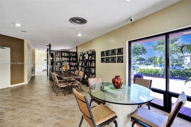 dining space with a textured ceiling