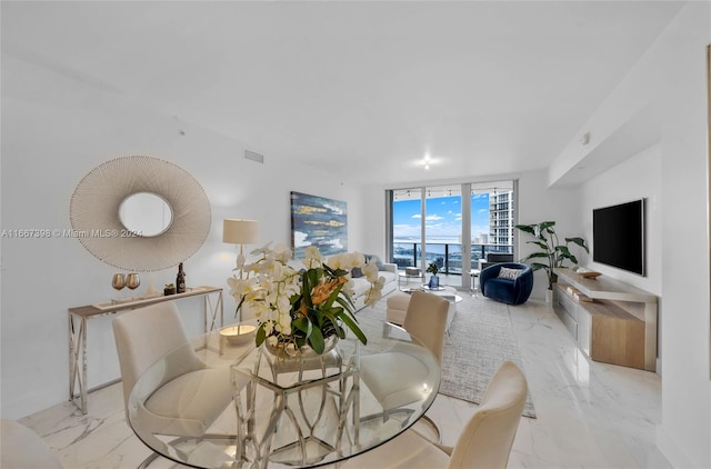 dining space featuring expansive windows