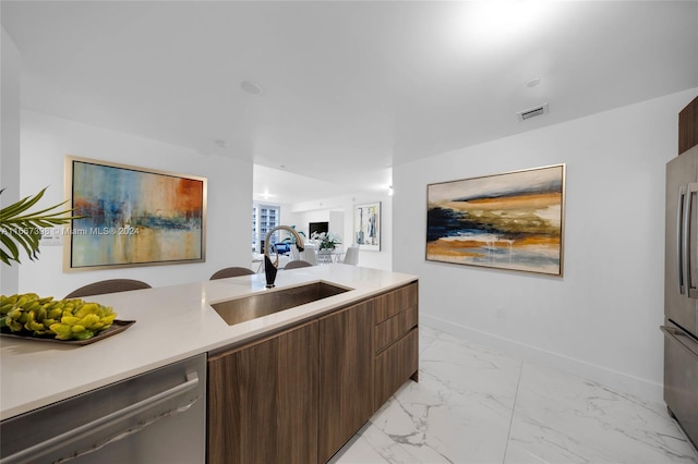 kitchen featuring dark brown cabinets, stainless steel dishwasher, and sink