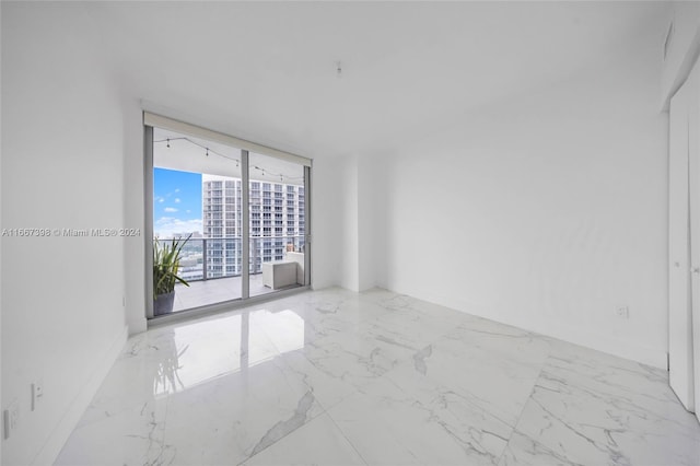 unfurnished room featuring expansive windows