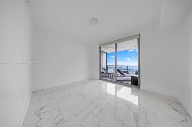 empty room featuring floor to ceiling windows