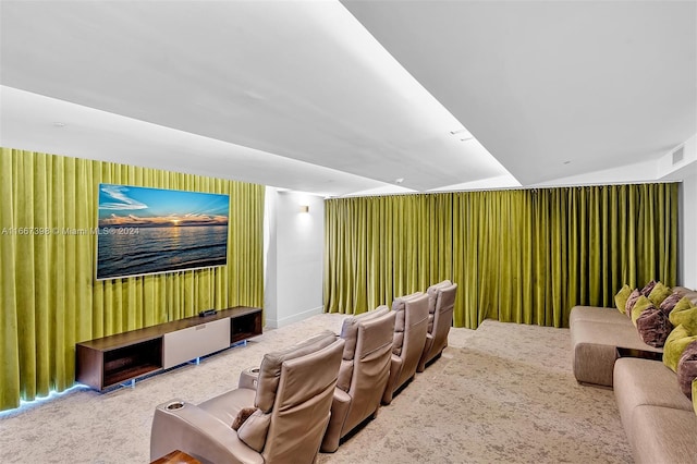 carpeted home theater featuring vaulted ceiling