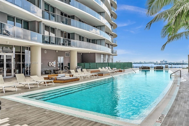 view of swimming pool featuring a water view