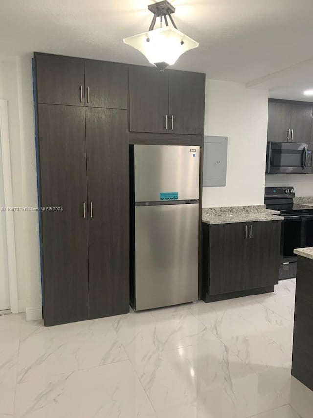 kitchen with dark brown cabinetry and appliances with stainless steel finishes