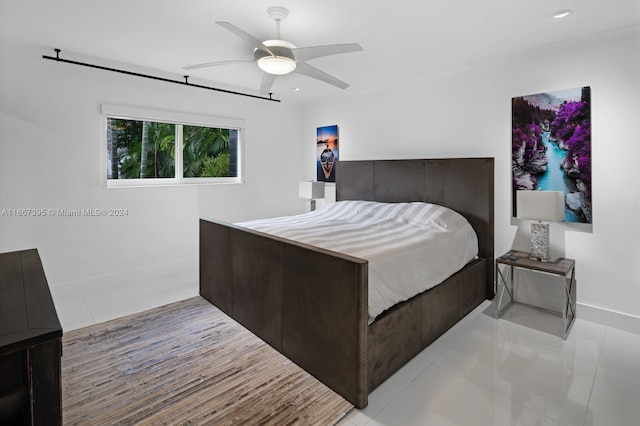 bedroom featuring ceiling fan and light tile patterned flooring