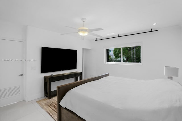 tiled bedroom with ceiling fan