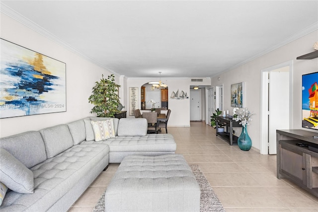 living room featuring crown molding, an inviting chandelier, and light tile patterned floors