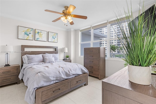 tiled bedroom featuring ornamental molding and ceiling fan