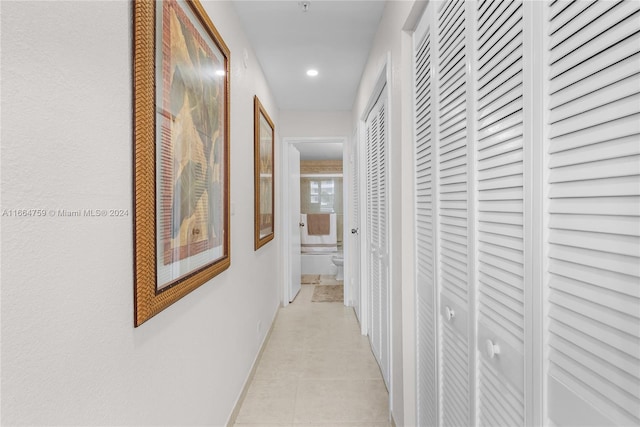 hallway featuring light tile patterned flooring