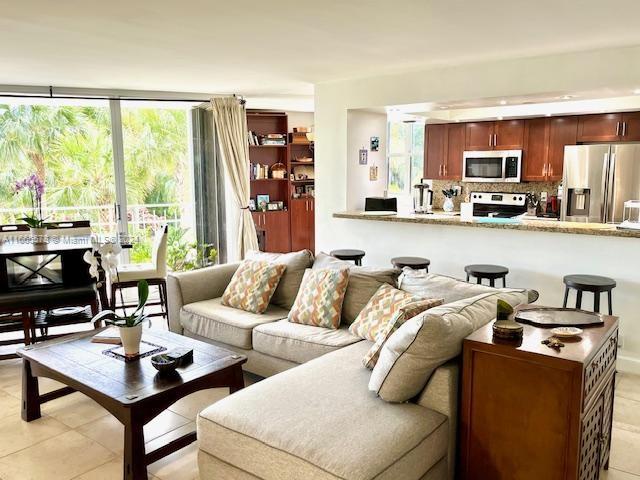 tiled living room with a wealth of natural light