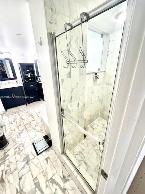 bathroom featuring a shower with door