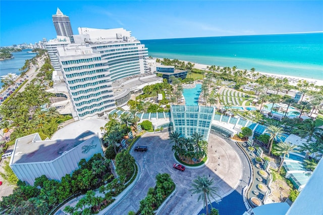 drone / aerial view with a water view and a beach view