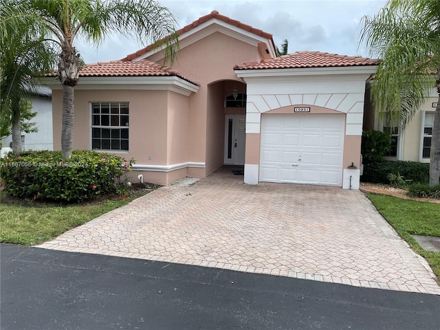 mediterranean / spanish-style house with a garage