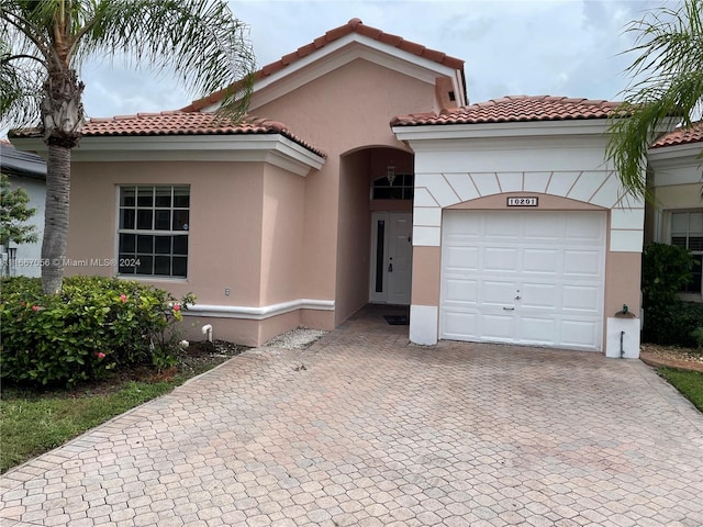 mediterranean / spanish-style house featuring a garage