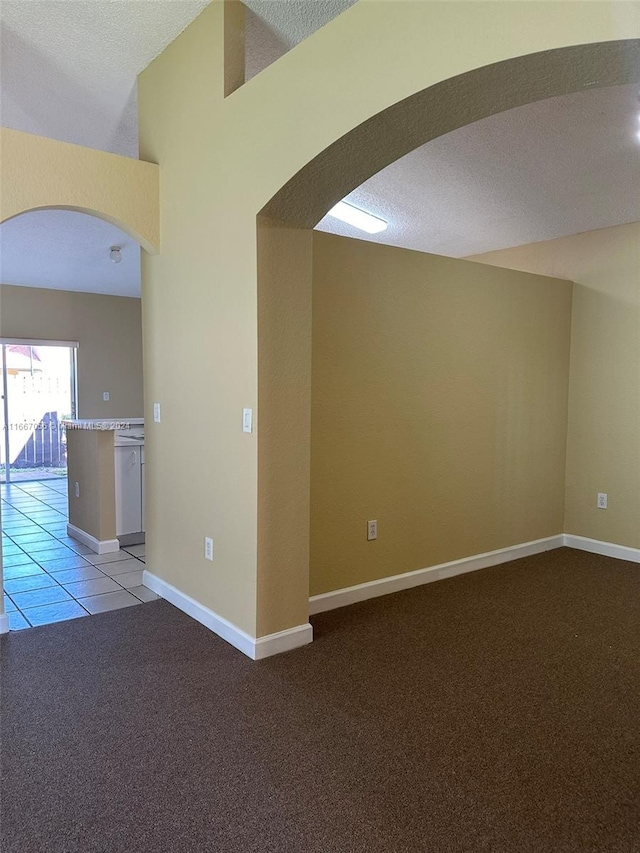 carpeted spare room featuring a textured ceiling