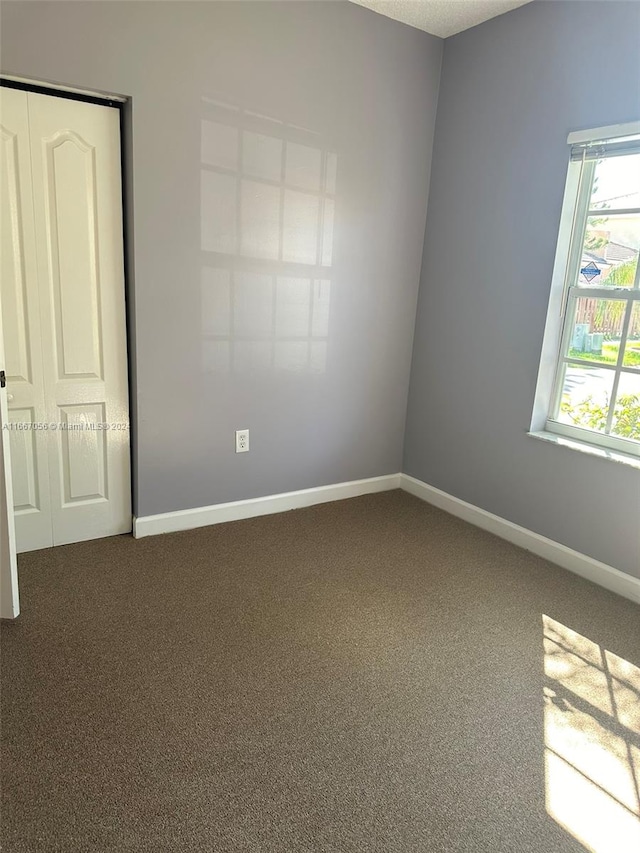 empty room featuring carpet flooring