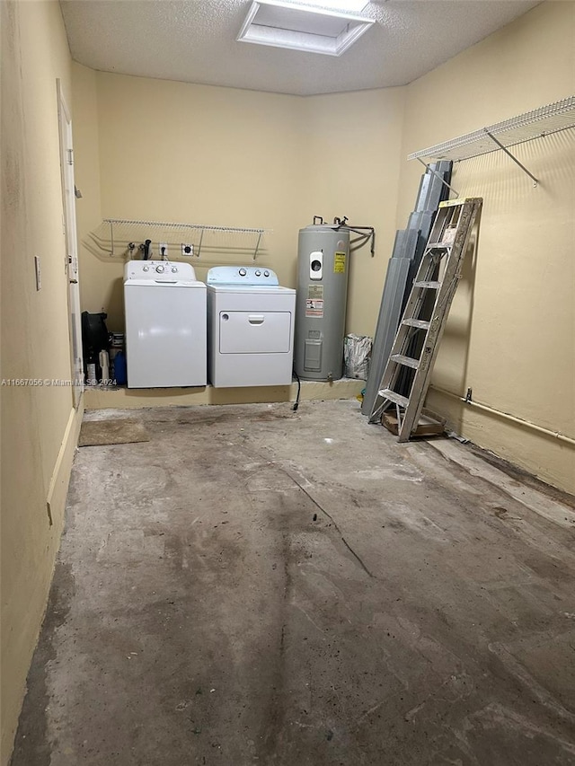 laundry area featuring electric water heater, a textured ceiling, and separate washer and dryer