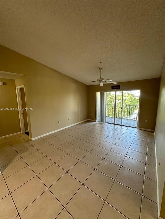 tiled spare room featuring ceiling fan and a textured ceiling