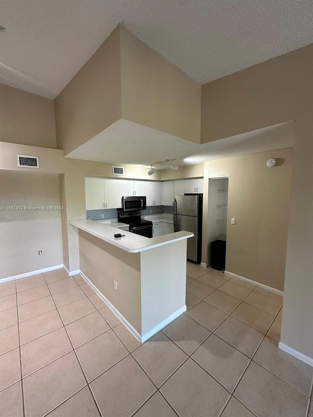 kitchen featuring kitchen peninsula, white cabinetry, light tile patterned floors, and stainless steel appliances