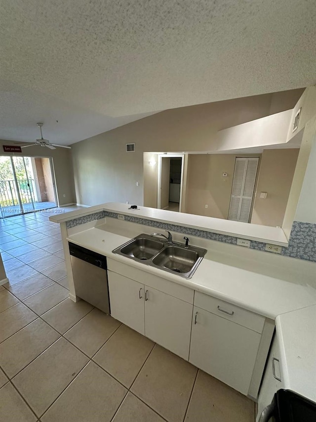 kitchen with white cabinetry, kitchen peninsula, a textured ceiling, stainless steel dishwasher, and sink