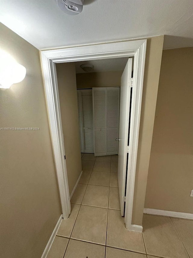 hallway with light tile patterned flooring