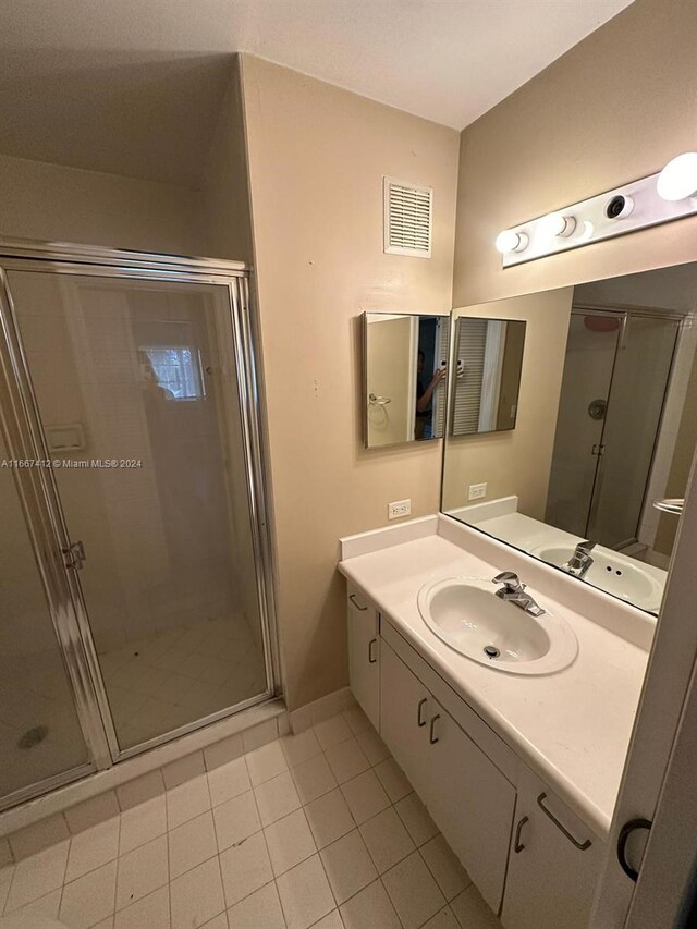 4848 N State Road 7 Unit 4305, Coconut Creek, FL 33073 - bathroom with tile patterned floors, vanity, and a stall shower
