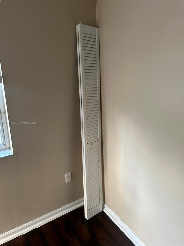 4848 N State Road 7 Unit 4305, Coconut Creek, FL 33073 - unfurnished bedroom featuring baseboards and dark wood-style floors